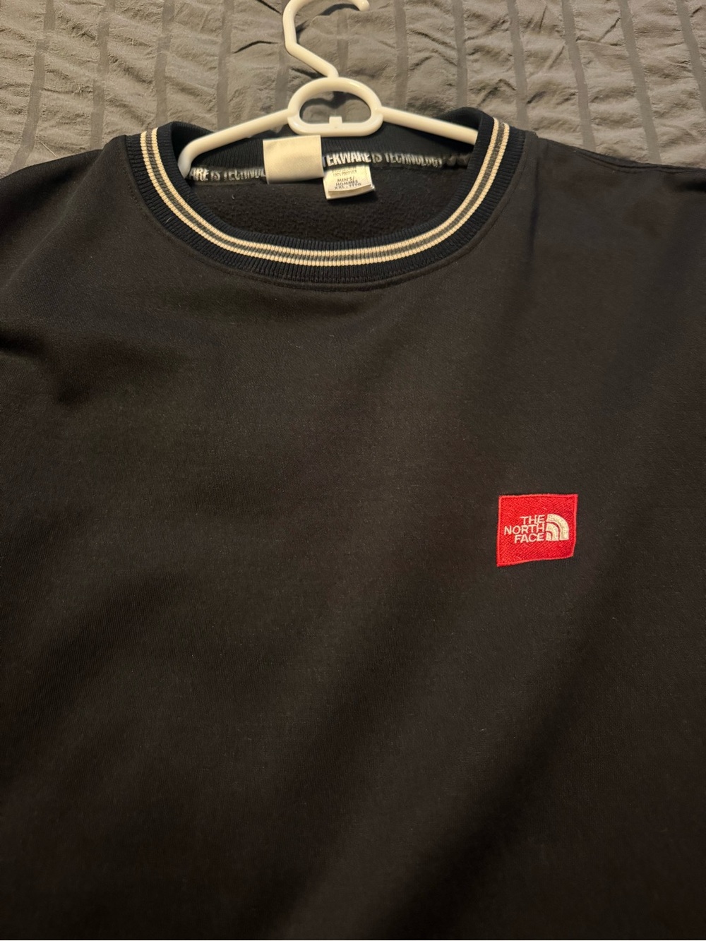 The North Face Black Crew Sweatshirt with Red Logo and Striped Neck